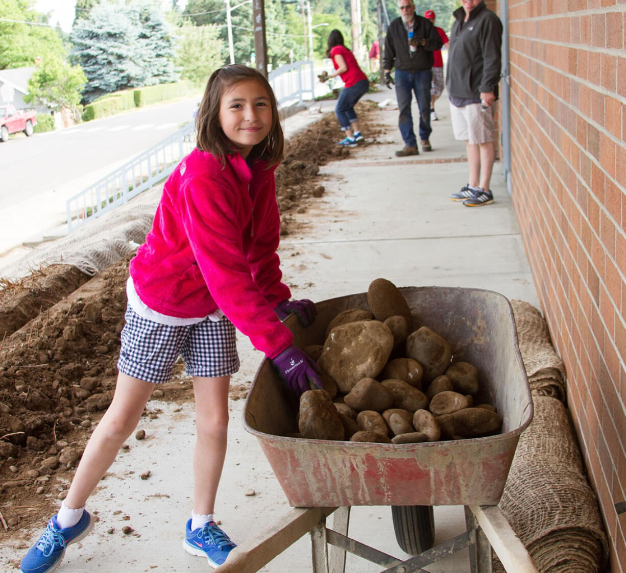 Ridgefield: Fourth-grader Natalie Brachvogel moves rocks in preparation of painting at Ridgefield Middle School as part of Ridgefield School District's Beautification Day.