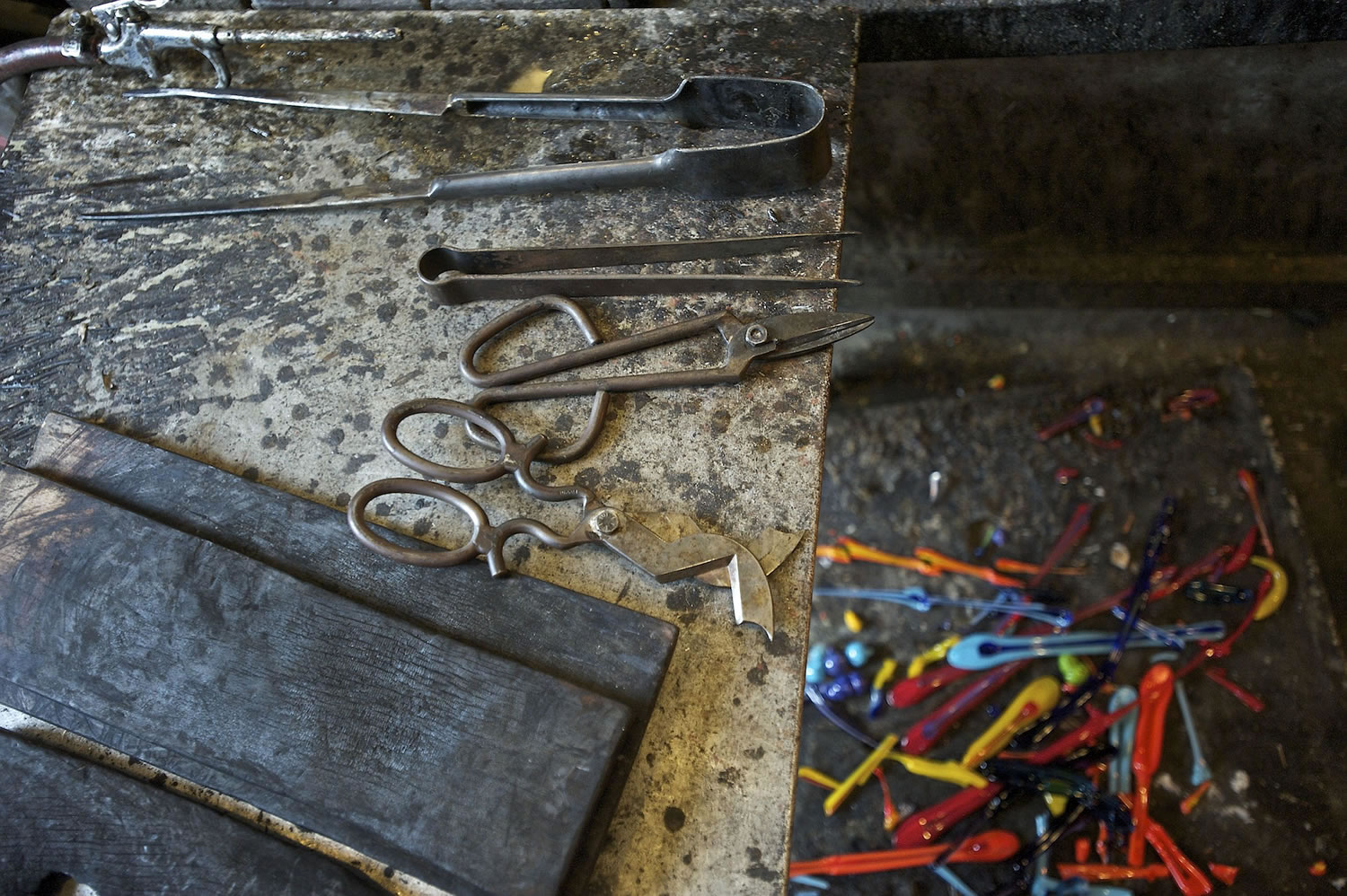 Tools on the left and glass drippings, on the right, are left out at Firehouse Glass Studio.