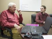 SCORE business mentor Paul Freeman, left, meets Wednesday with a small business client, microbrewer Adam Faeh, at the SCORE office in Vancouver.