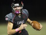 Camas quarterback Liam Fitzgerald holds on to the ball and runs for a touchdown to take a 14-7 lead over Skyview in the first half at Doc Harris Stadium on Friday