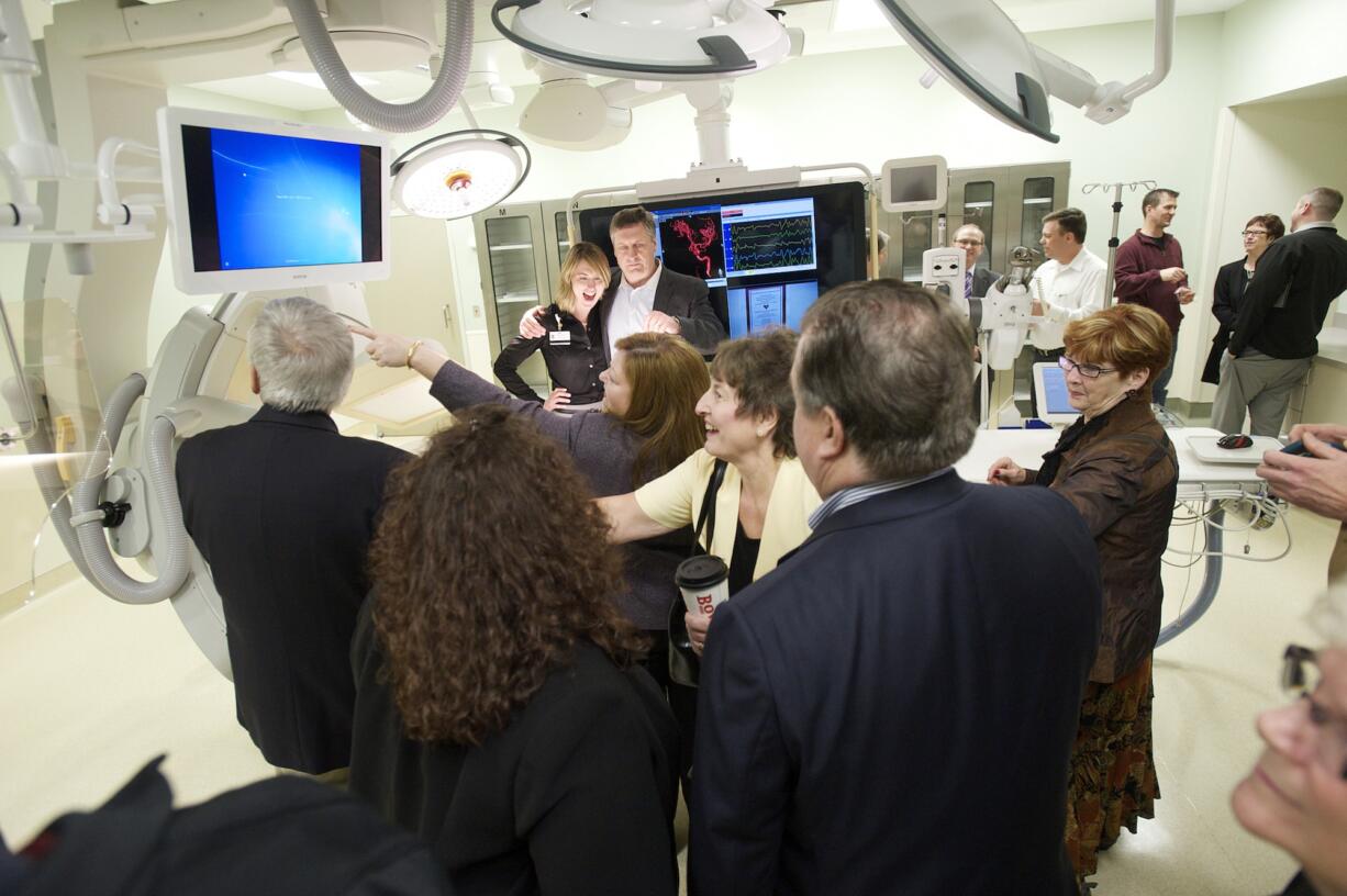 Photos by Steven Lane/The Columbian
People attend a ceremony Tuesday to bless the new $2.1 million Heart and Vascular Center Hybrid Catheterization Surgical Suite at PeaceHealth Southwest Medical Center. The PeaceHealth Southwest Foundation raised $522,000 for the project through its HeArts of Clark County fundraiser in 2013. Top: Surgeons can view multiple types of images while they're operating in the suite.