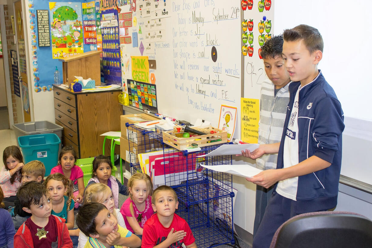 Ridgefield: South Ridge Elementary School sixth-graders Fernando Jimenez and Cade Bringhurst help kindergartners brainstorm story ideas as part of a school-wide writing project that will culminate in a completed book at the end of the school year.