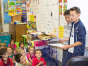 Ridgefield: South Ridge Elementary School sixth-graders Fernando Jimenez and Cade Bringhurst help kindergartners brainstorm story ideas as part of a school-wide writing project that will culminate in a completed book at the end of the school year.