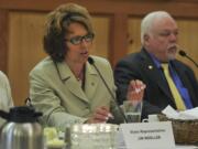 Rep. Liz Pike, R-Camas, center, speaks to lawmakers at a legislative review luncheon at the Heathman Lodge in Vancouver on Tuesday. Flanking Pike are Rep. Jim Moeller, D-Vancouver, left, and Sen.