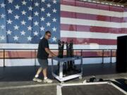 Darren Erickson of Woodland prepares the main stage for Independence Day festivities at Fort Vancouver on Friday.