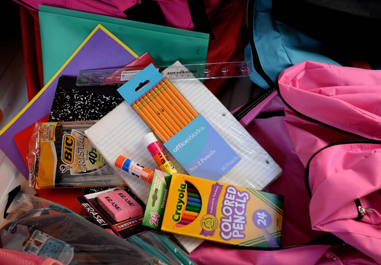 Crews from Vancouver Public Schools' Family-Community Resource Centers collected donated backpacks and school supplies for low-income students at Divine Consign on Thursday.