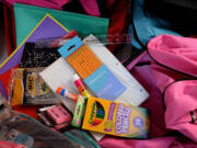 Crews from Vancouver Public Schools' Family-Community Resource Centers collected donated backpacks and school supplies for low-income students at Divine Consign on Thursday.