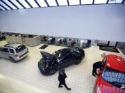 Sales associates check the showroom floor Friday at Vancouver Ford.