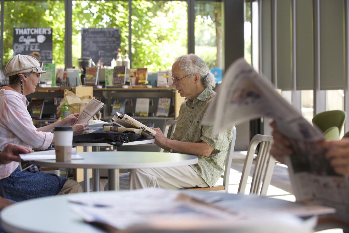 Al and Kathy Salle take time to read at the Vancouver Community Library.