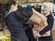 Megan Waller, 18, right, hands off bags of items donated for the 28th annual Walk