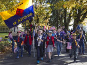 Cub Scout Pack 95 walks in the 28th annual Lough Legacy Veterans Parade at Fort Vancouver on Saturday.