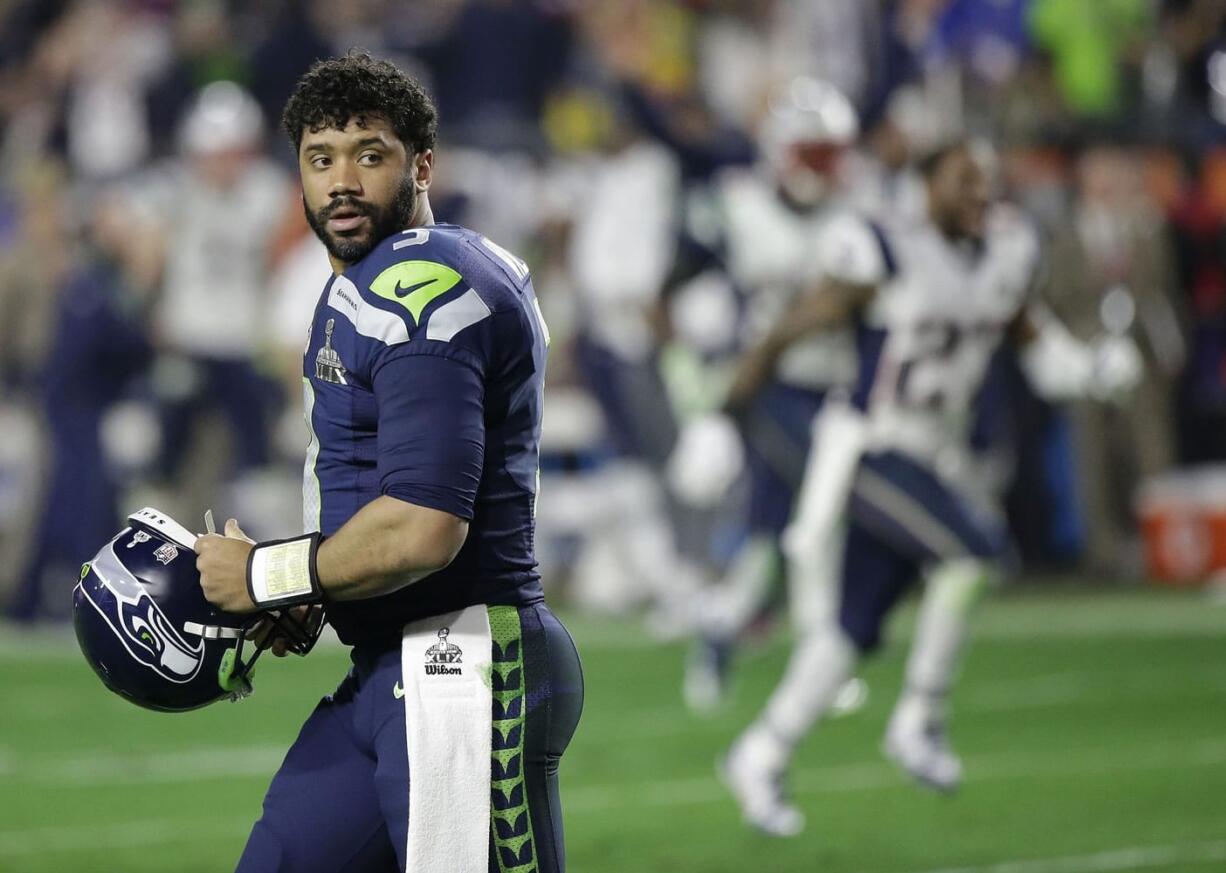 Seattle Seahawks quarterback Russell Wilson (3) looks back after throwing an interception to New England Patriots strong safety Malcolm Butler during the closing seconds of the fourth quarter of Super Bowl XLIX on Sunday, Feb.