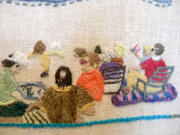 Eileen Ono, center in the salmon-colored blouse, stitches on a panel of the Fort Vancouver Tapestry with other women in the tapestry's image of a July 4 fireworks show.