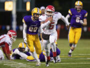 Marysville Pilchuck running back Austin Joyner carries the ball against Columbia River in the 3A state quarterfinal game at Kiggins Bowl, Saturday, November 22, 2014.