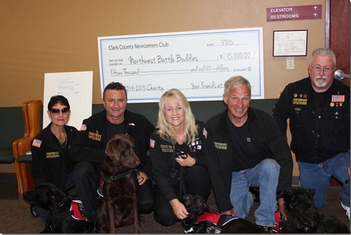 Battle Ground: Northwest Battle Buddies President Shannon Walker, center, with a few veterans accepting a donation from the Clark County Newcomers Club.