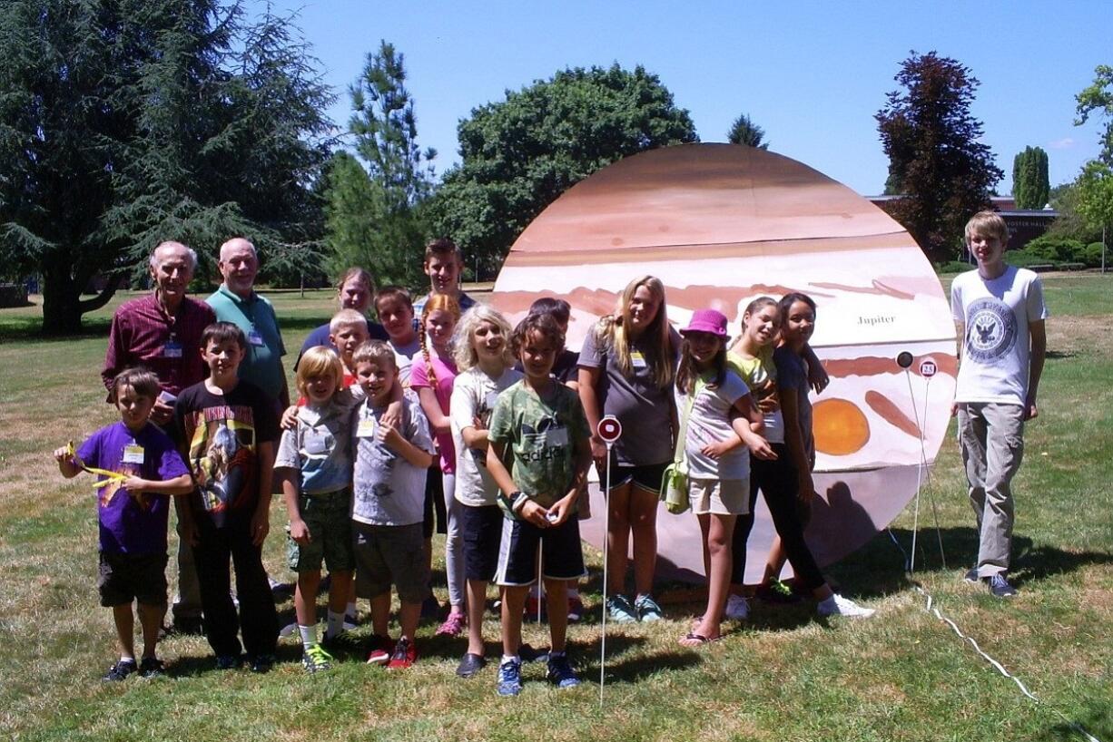 Central Park: Middle School students in Clark College?s Economic and Community Development's Science, Technology, Engineering and Math Camp with model planets they lined up all around campus.