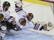 Portland goaltender Adin Hill makes a save that is later ruled a goal as the Portland Winterhawks take on the Kelowna Rockets at the Moda Center, Tuesday, April 28, 2015.