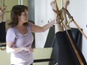 Ariane Kunze/The Columbian
Laura Kotsovos of Camas practices teaching Pilates to her instructor Jessica Schultz during a lesson Tuesday at Jessica Schultz Pilates in Portland. Kotsovos, 39, was diagnosed with cerebral palsy as an infant and is now training to be a Pilates instructor