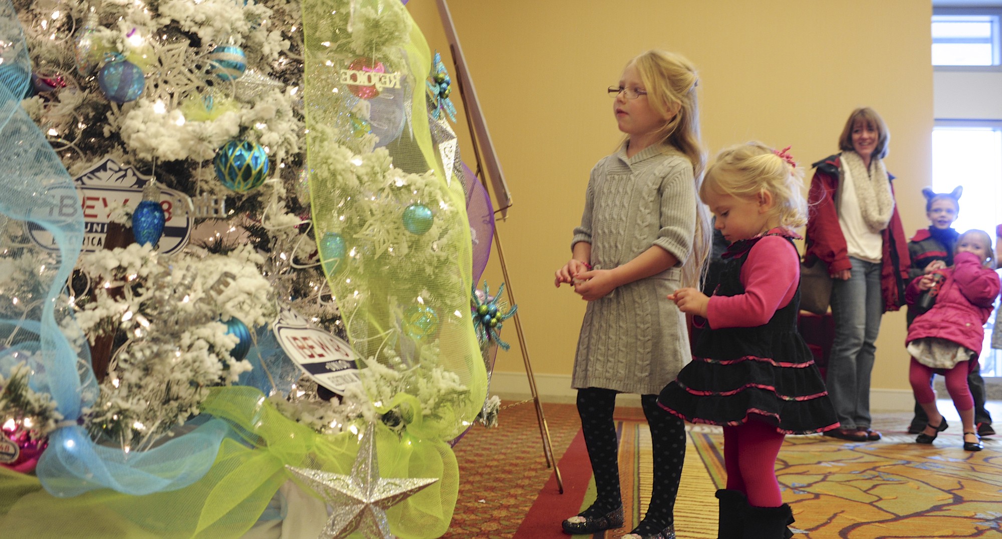 Ella Bardzik, center, and Ruby Bardziik chat with the talking tree at the Festival of Trees at the Hilton Vancouver Washington.