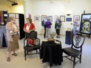 Photos by Amanda Cowan/The Columbian
Linda Andrews-Riggs of Vancouver, left, and Myrna Leija discuss the non-juried -- that is, open to all applicants -- &quot;Art in the Heart&quot; gallery show at Gallery 360 during the Aug. 7 First Friday Art Walk. Top: Art On The Boulevard gallery volunteer Ernie Veach-White, left, chats with Vancouver painter Michael Lindstrom during the art walk. Lindstrom said he and his fellow artists routinely collect one another's work -- both because they love art and because they need to support one another.