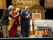 Arun Gandhi, from left, prays with the Dalai Lama and Martin Luther King III, son of the Rev. Dr.