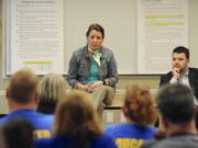 Sen. Ann Rivers, center, and Rep. Brandon Vick talk with teachers about funding K-12 education at the Camas Public Library on Saturday.