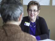 Kathy McLaughlin meets with a client at A Caring Heart Housing Referral Service on Tuesday in Vancouver.