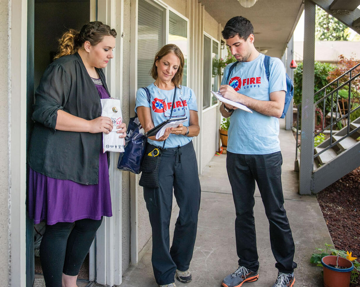 Vancouver Fire Department
Vancouver Fire Corps volunteers Nina and Ryan Cavola speak with a Cascade Park neighborhood resident about preventing home fires.