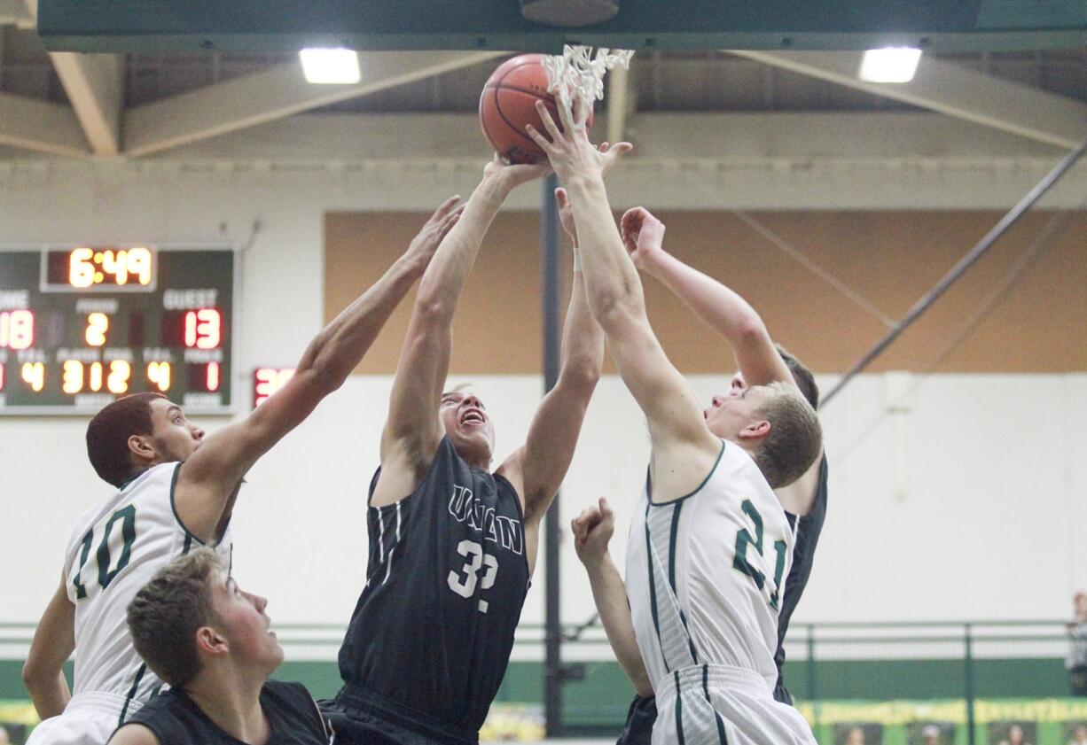 Union's Riley Hawken tries to score while Evergreen's Michael Bozovoch, left, and Mitchell Carnahan try to stop him Friday at Evergreen High School in Vancouver.