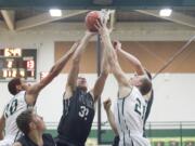 Union's Riley Hawken tries to score while Evergreen's Michael Bozovoch, left, and Mitchell Carnahan try to stop him Friday at Evergreen High School in Vancouver.