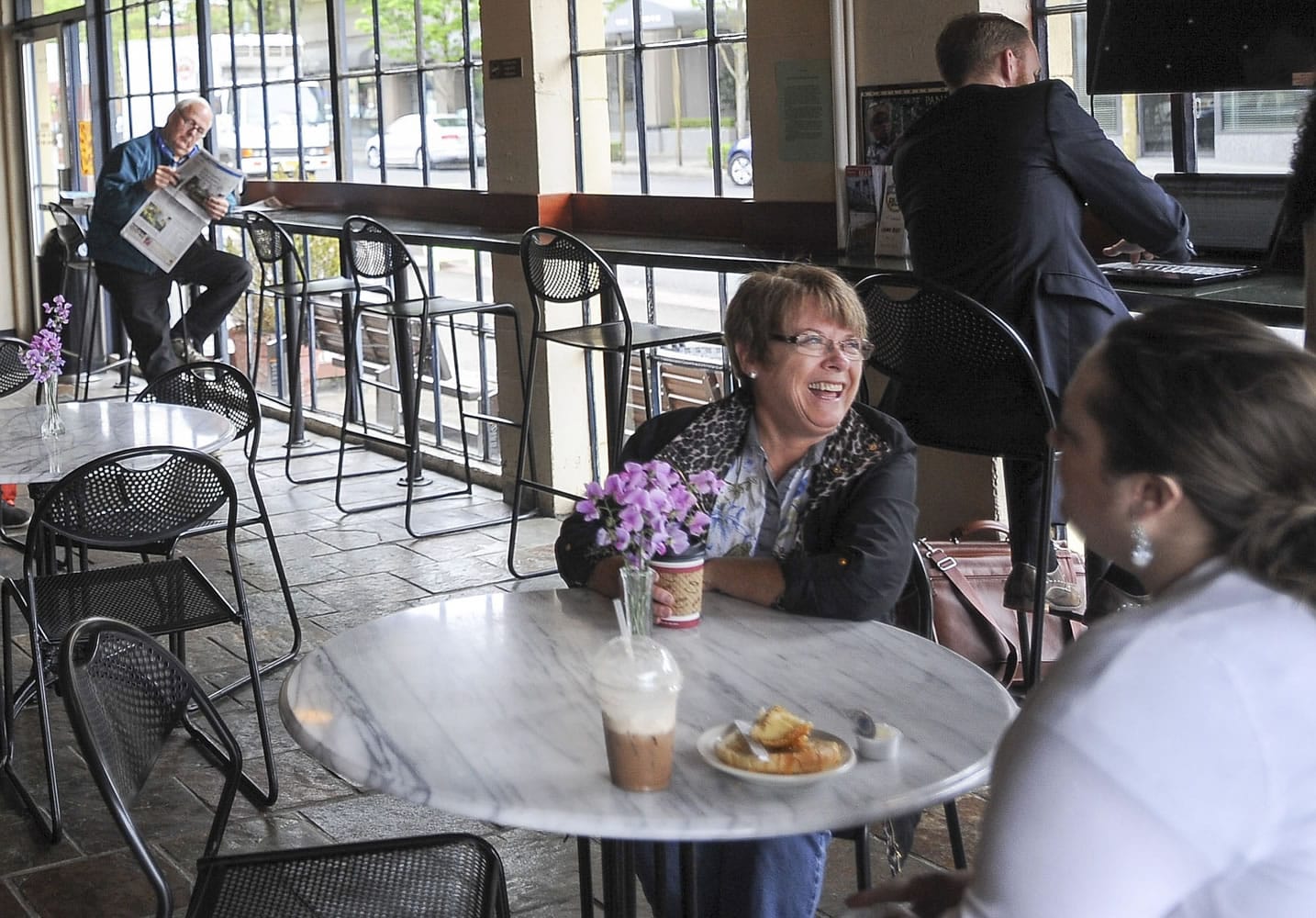 Customers enjoy coffee and pastries at the Java House, which is celebrating its 25th anniversary.