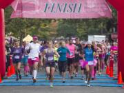 Participants in the Girlfriends Run for a Cure set off from the starting line Sunday in downtown Vancouver. Organizers said about 1,500 people registered to take part in the event, which raises money for the nonprofit Susan G.