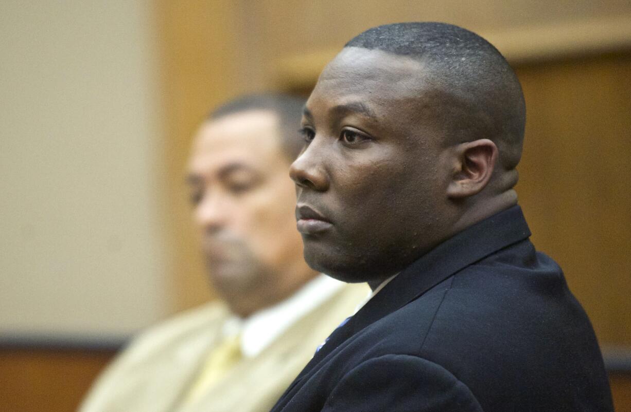 Former Beaverton, Ore., police Officer Christopher Warren stands Monday as the jury enters the courtroom of Superior Court Judge Barbara Johnson before opening statements in his child rape trial.