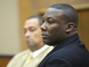 Former Beaverton, Ore., police Officer Christopher Warren stands Monday as the jury enters the courtroom of Superior Court Judge Barbara Johnson before opening statements in his child rape trial.