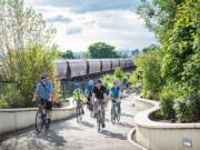 Esther Short: Urban forestry specialist Nick Redmond, center in dark blue, leads the annual Heritage Tree Bike Ride over the State Highway 14 land bridge.