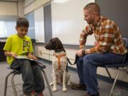 Ridgewood: Union Ridge Elementary School first-grader Rick Alanis reads to therapy dog Bruno and Jason Winters, who visited the school each week with the dog through Columbia River Pet Partners.