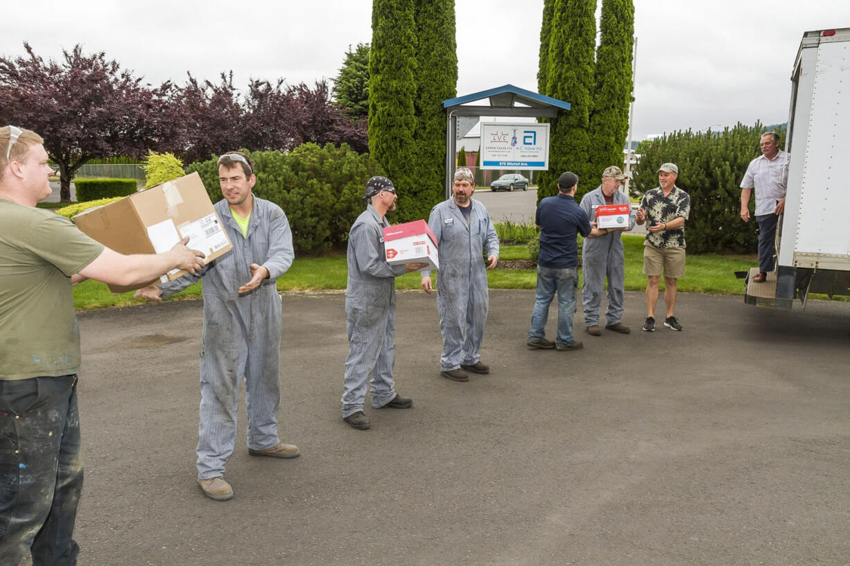 Woodland: Employees from Lined Valve Company load up 20 boxes of food, clothing and personal items they donated to the Woodland Action Center to celebrate the company's 20th anniversary.