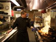 Chef Tim McCusker prepares a dish at his new restaurant, Feast at 316, in downtown Camas.