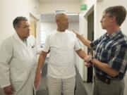 Physical therapist Jeff Gulliford, right, and Dr. David Griffin, left, screen patient Ron Hamilton for balance issues at the Kaiser Permanente Mill Plain medical office.