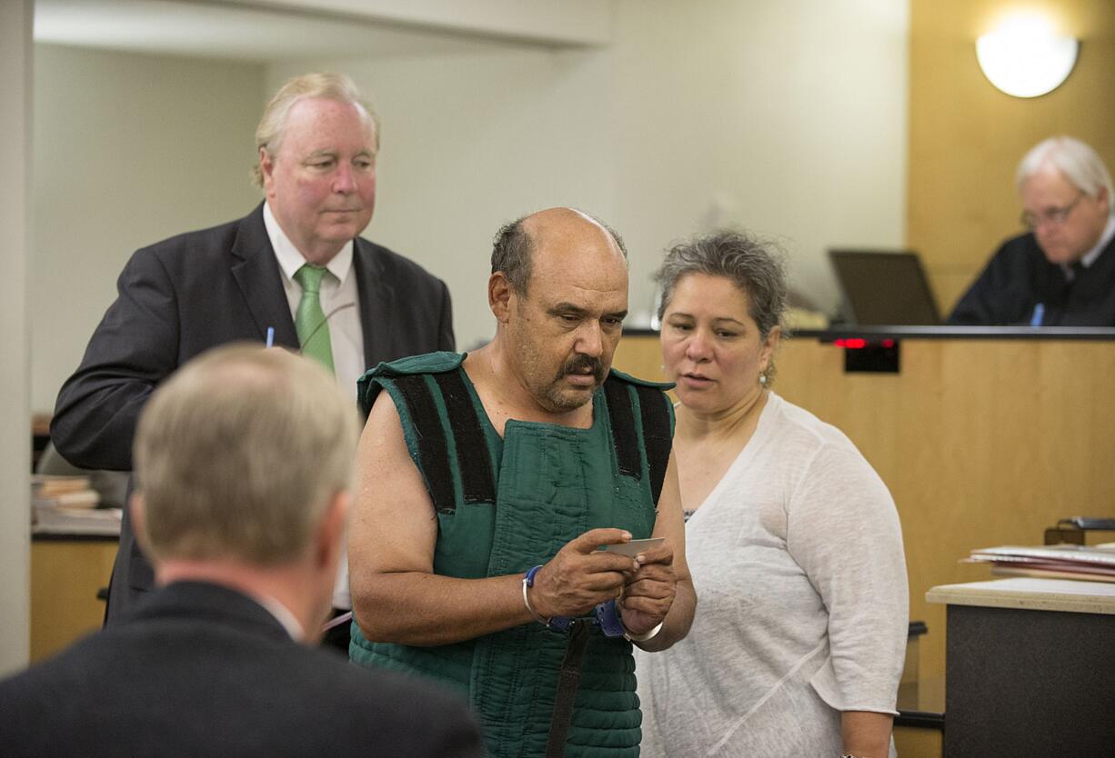 Samuel U. Morales of Woodland, center, makes a first appearance Friday in Clark County Superior Court after allegedly setting fires along Interstate 5 south of Ridgefield on Wednesday.