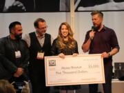 Hairstylist Alyssa Brasket, second from right, of Camas is flanked by Sergi Bancells of Estetica USA, from left, Martin Flaherty of Revlon Professional Brands and Kevin Grieve of American Crew as she receives an award after winning the American Crew U.S. All-Star Challenge on Jan. 25 in Long Beach, Calif.