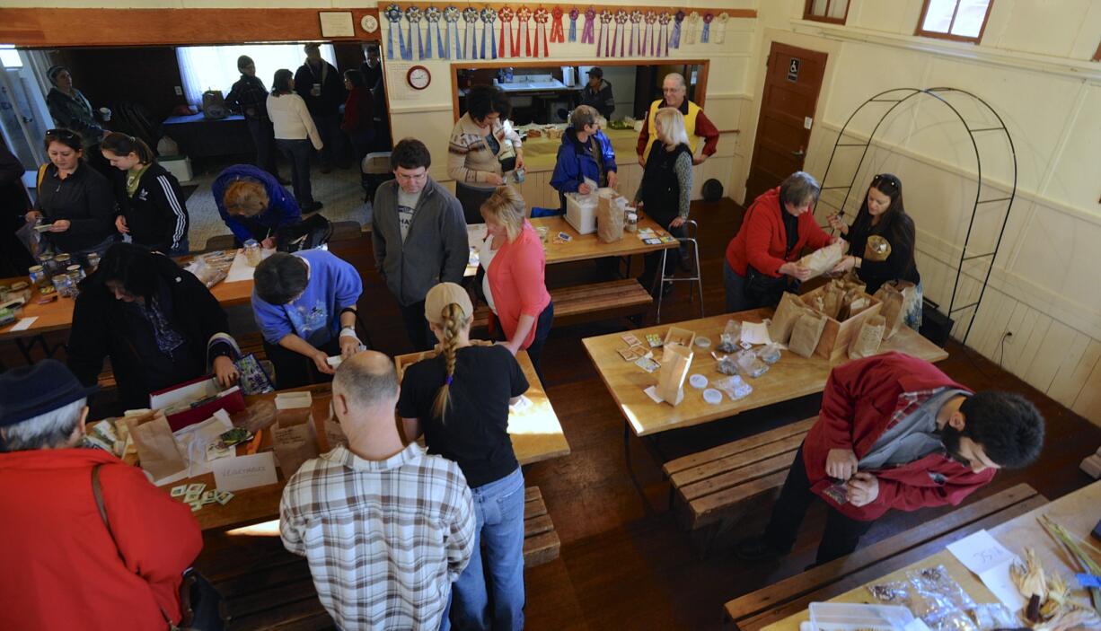 Gardening enthusiasts exchange seeds at the Venersborg Schoolhouse on Sunday in Battle Ground.