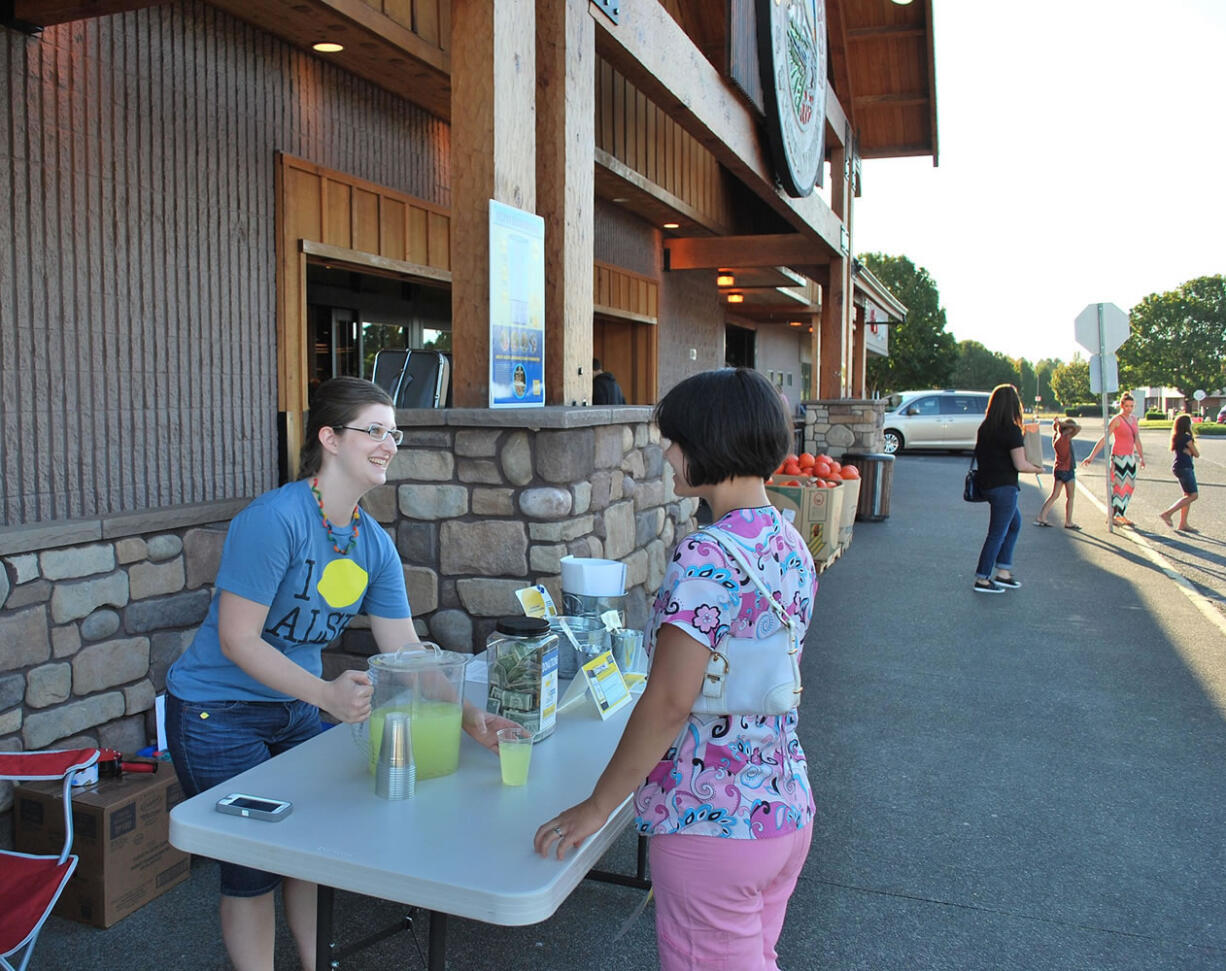 Mountain View: Monica Loomis serves lemonade to Jensena Jones on Sept.