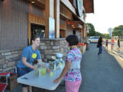 Mountain View: Monica Loomis serves lemonade to Jensena Jones on Sept.