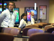 Zachary Kaufman/The Columbian
Blackjack dealer Josh Skucas, 33, stands at an empty table at the Oak Tree's casino in Woodland on Tuesday. Card rooms have struggled to earn money locally, impacting the cities that collect taxes from them.