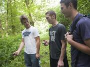 Hunter Cofer, from left, Kyler Clary and Kyle Campbell, Advanced Placement biology students at Prairie High School, research a plot of forest in Brush Prairie on June 4.