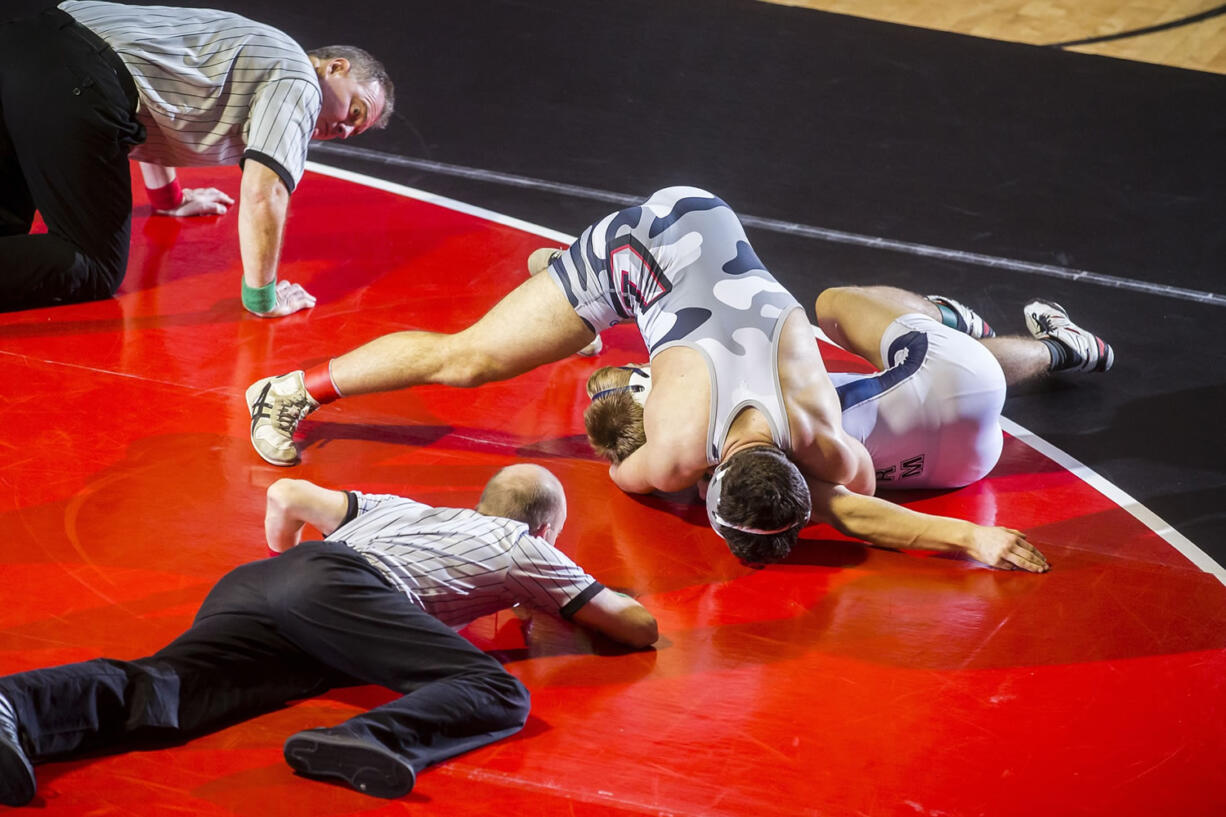 Union's Michael Snediker (top) works on pinning Skyview's Cameron Hutchison in the finals of the 160-pound weight class. Snediker pinned Hutchison in 1 minute, 23 seconds to win the district title.