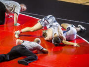 Union's Michael Snediker (top) works on pinning Skyview's Cameron Hutchison in the finals of the 160-pound weight class. Snediker pinned Hutchison in 1 minute, 23 seconds to win the district title.