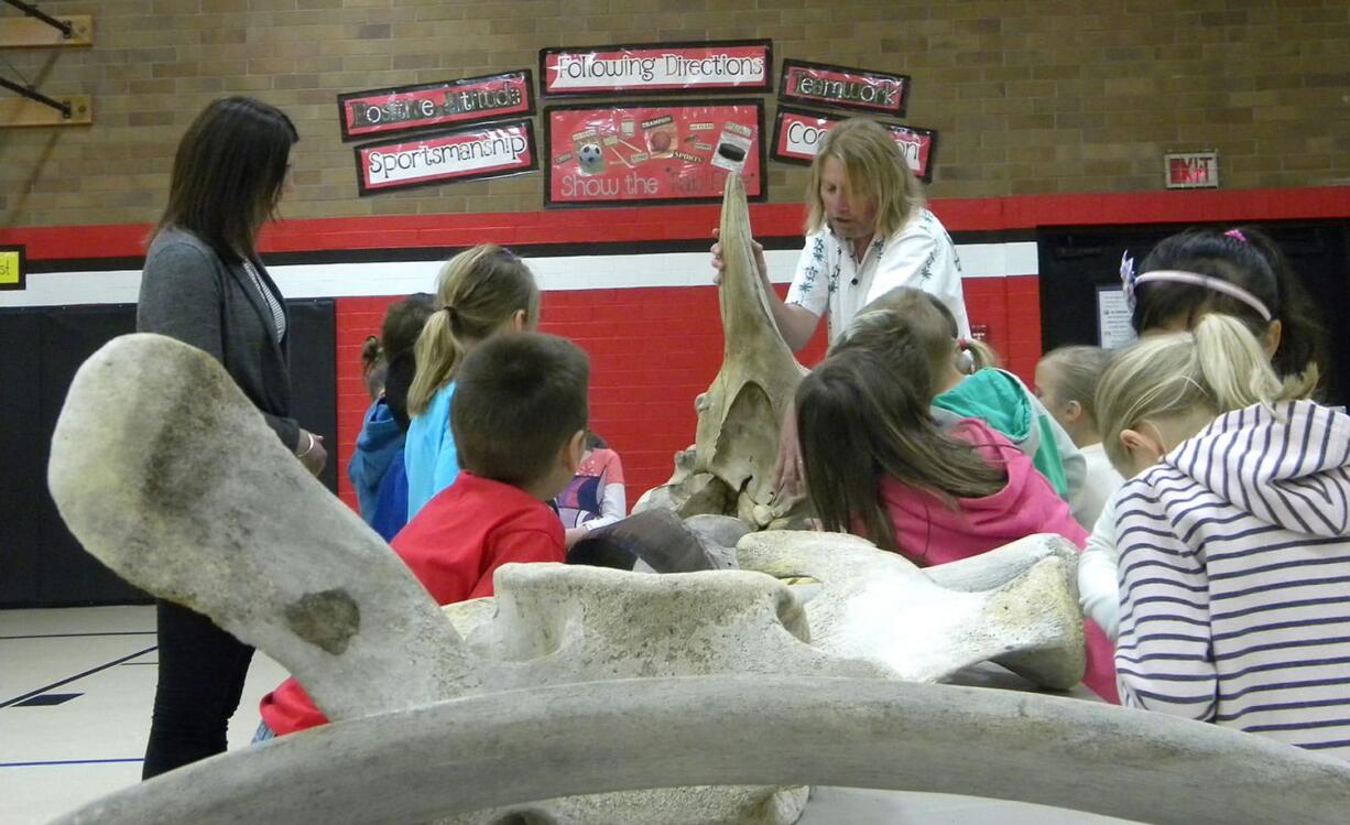 Photos by Adam Littman/The Columbian
John L. Ford shows Woodland Primary School first-graders different whale bones as part of his annual program at the school, which celebrated its 30th anniversary on Wednesday.