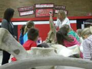 Photos by Adam Littman/The Columbian
John L. Ford shows Woodland Primary School first-graders different whale bones as part of his annual program at the school, which celebrated its 30th anniversary on Wednesday.